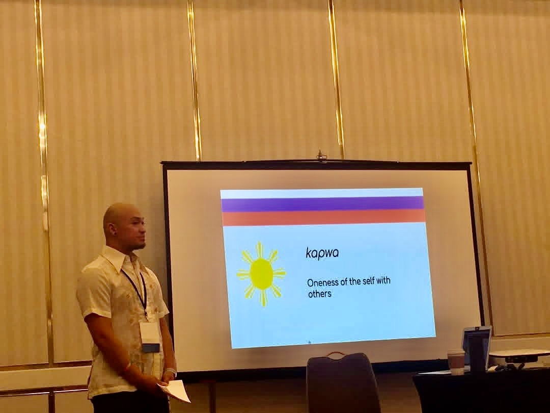 Zano presenting beside a slide reading 'kapwa — Oneness of the self with others'.